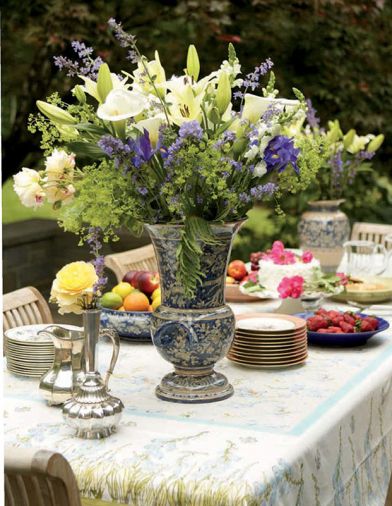 Collections of vases and china are showcased when Liz Williams entertains. The flower arrangement contains Asiatic lilies, Calla lilies, roses, catmint, and lady’s mantle, all from the garden.