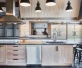 The commercial kitchen features industrial pendant lamps imported from Europe, a professional wood burning Mugnaini pizza oven, Perlick refrigerator drawers, wine and beverage coolers.