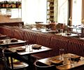 The dining room is bisected by a leather-coated banquette that runs nearly the entire length of the restaurant.