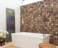 Ewan created a custom tile accent wall for the bathroom from reclaimed barn wood recycled into square tiles that are set randomly, with horizontal and vertical grain. “The tiles are not absolutely flush,” says Ewan, “so it brings in some of that rustic element and avoids feeling stark or cold, but it still doesn’t overpower the modern aesthetic.”
