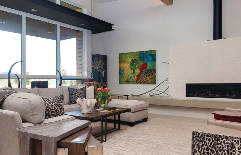 A custom gas fireplace brings a horizontal element into the living room. Encased in simple white porcelain tile in a linear grid form typical of mid-century style, it provides a commanding centerpiece yet retains a light, simple look.
