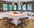 The Guggenheims selected Ann Sacks Savoy textured bronze field tiles to reflect the Dutch Colonial period. The walnut stools are from CB2. Three banks of Milgard Essence series windows from Portland Millwork add light and a view of backyard/street.