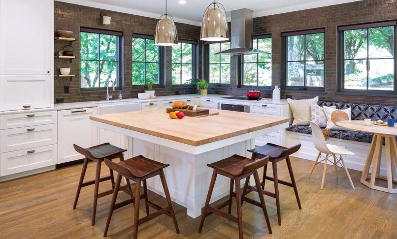 The Guggenheims selected Ann Sacks Savoy textured bronze field tiles to reflect the Dutch Colonial period. The walnut stools are from CB2. Three banks of Milgard Essence series windows from Portland Millwork add light and a view of backyard/street.