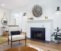 The couple’s dark iron coral piece adds visual contrast to the original fireplace surround and mantel painted with Benjamin Moore Simply White. The sconces are from Schoolhouse Electric.