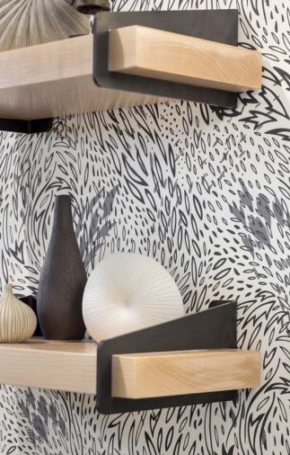 A jaunty Hygge & West modern wallpaper adds zest to the room. The shelf and brackets are from Quartertwenty.