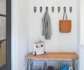 A mudroom located near the backyard entrance from the detached garage features a custom bench by Tretiak Works fashioned from fir recycled from the home.