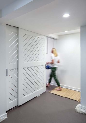 A custom basement utility door designed in collaboration with Birdsmouth lets in light and encourages airflow.