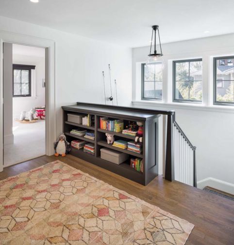 To make the home more livable with a toddler and baby, the master and two children's bedrooms are gathered together on the top floor. A large landing serves as a play area and laundry rolled into one.