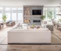 While the custom fireplace is strongly asymmetrical, its placement provides a strong vertical center for the windows that flank it on either side. High-end Marvin windows from Portland Millwork keep the home well insulated even during the stormiest days, particularly important for a home this close to the water.