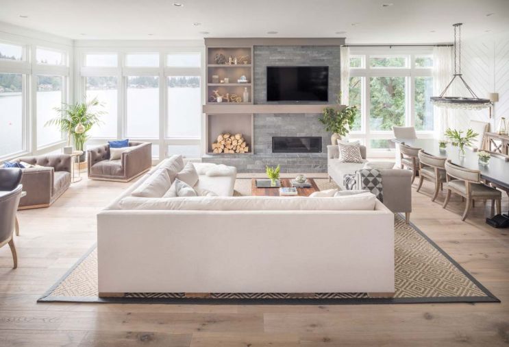 While the custom fireplace is strongly asymmetrical, its placement provides a strong vertical center for the windows that flank it on either side. High-end Marvin windows from Portland Millwork keep the home well insulated even during the stormiest days, particularly important for a home this close to the water.