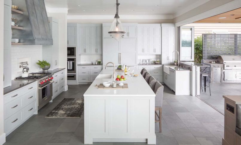 One of the homeowners is a serious home cook, so designing a beautiful, functional kitchen for family and entertaining was a major focus of the design process. “The goal was to make the kitchen super functional but still have visual balance,” explains Baines. “We tried to create as much symmetry in the space as we could, and create a geometric rhythm that moves around the space.” Mostly neutral colors are accented by whimsical bright red knobs on the professional-grade range.