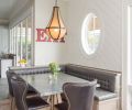 A combination of different leather finishes on chairs and built-in benches provides subtle visual interest at the dining nook.