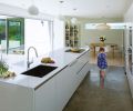 What was once a dark, cramped kitchen in a Seattle suburb is now filled with light and a nearly seamless connection to the outdoors – perfect for the family of five who lives here.