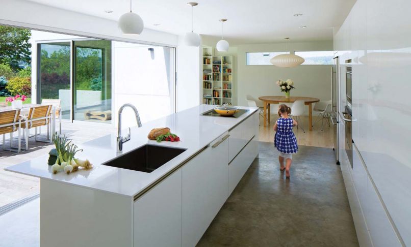 What was once a dark, cramped kitchen in a Seattle suburb is now filled with light and a nearly seamless connection to the outdoors – perfect for the family of five who lives here.