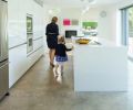 “The neutral monotone works really well with the surrounding cool concrete flooring in the kitchen and as a counterpoint to the warmer finishes and accents in the living and dining rooms,” explains designer Cathleen Summers of Summers Studio.