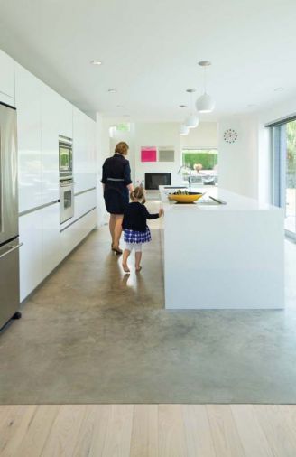 “The neutral monotone works really well with the surrounding cool concrete flooring in the kitchen and as a counterpoint to the warmer finishes and accents in the living and dining rooms,” explains designer Cathleen Summers of Summers Studio.