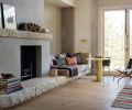 “The concept for the stone and adjacent walls follows the idea of making surfaces warm, tactile, and connected to nature outside, in tradition of Wabi-Sabi aesthetics of things imperfect and impermanent,” explains interior designer Maryika Byskiniewicz of Spaces.