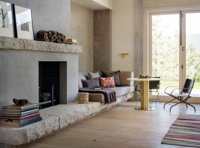 “The concept for the stone and adjacent walls follows the idea of making surfaces warm, tactile, and connected to nature outside, in tradition of Wabi-Sabi aesthetics of things imperfect and impermanent,” explains interior designer Maryika Byskiniewicz of Spaces.
