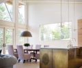 “DMA built the brass panels and was instrumental in developing the finish, which allows the material to breathe and evolve over time,” says Byskiniewicz. The dining room light fixture by the Italian company Il Fanale is 31.5” in diameter. Made of steel with gold leaf interior, it casts a warm glow over the dining table. A new horizontal window frames the mountainous landscape.