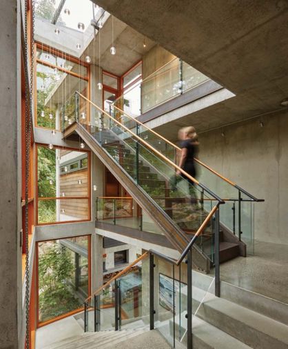 Three stories of living space are linked with a steel and concrete staircase illuminated by a custom LED light fixture made from hand-cast glass globes. “It’s so beautiful at night,” says McClellan. “You can see the light fixture from the entry door, and it reflects in the windows and the glass railing so it appears there are about three times more lights than there really are.”