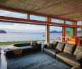 From the living room, residents can experience both sides of the landscape: expansive views over Chuckanut Bay, and the soothing green and grey mosaic of the uphill landscaping, cradling the home in natural textures and surfaces.