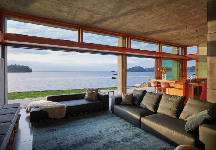 From the living room, residents can experience both sides of the landscape: expansive views over Chuckanut Bay, and the soothing green and grey mosaic of the uphill landscaping, cradling the home in natural textures and surfaces.