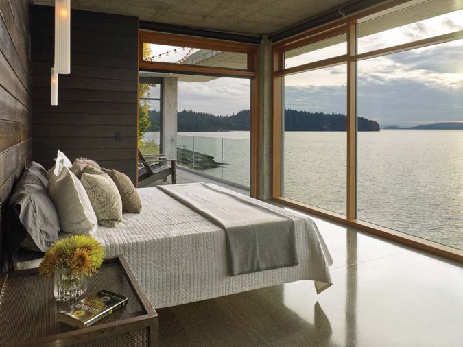 The master bedroom’s remarkable built-in bed is cantilevered out above the polished concrete floor on a steel frame, creating a spacious, airy feel with minimalistic lines. Wire-brushed burned cedar is featured here, too, providing an earthy mahogany counterpoint.