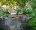 A quiet reading spot was designed to take advantage of the sunniest corner of the garden. The rebuilt fence and plantings provide privacy. Bluestone pavers were used throughout the landscape.