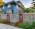 A reconstructed fence and front gate provide a more welcoming entry to the home.