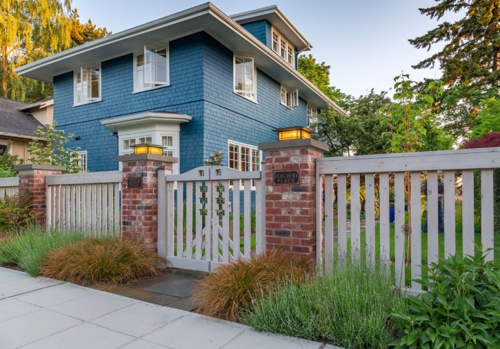 A reconstructed fence and front gate provide a more welcoming entry to the home.