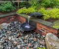 Water flows down the tiers of spun copper bowls and disappears in a cistern under pebbles where it recirculates back to the start of the sequence. A waterproof up light provides drama at night.