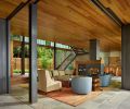 A courtyard defines the first of several spaces leading to the lake. Contrasting finishes differentiate the various wood species. Windows were supplied by Sierra Pacific Windows.