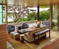 Walnut fireplace with blackened steel chimney echoes Weiland lift and slide doors that create seamless passage indoors and out.