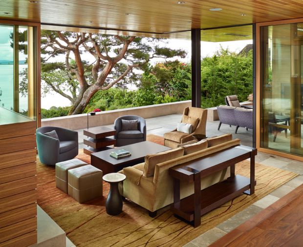 Walnut fireplace with blackened steel chimney echoes Weiland lift and slide doors that create seamless passage indoors and out.