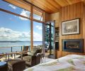 aster bedroom with built-in fireplace, private deck overlooking lake.