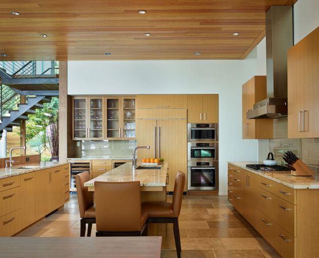 Burfiend and DeForest designed custom rift cut white oak cabinets and a plain sawn walnut island by Woodway Woodworks.