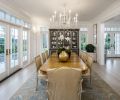 An oak dining table that belonged to the homeowner’s grandmother gives the home a sense of history and provides seating for up to ten. Colors in the area rug carry through on the blue tones seen throughout the home. Far wall was designed to accommodate the couple’s existing china cabinet.