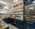 The pantry’s shelving and cabinets hold a wine refrigerator and storage space for the family’s bulk purchases. Counters are from Ikea.