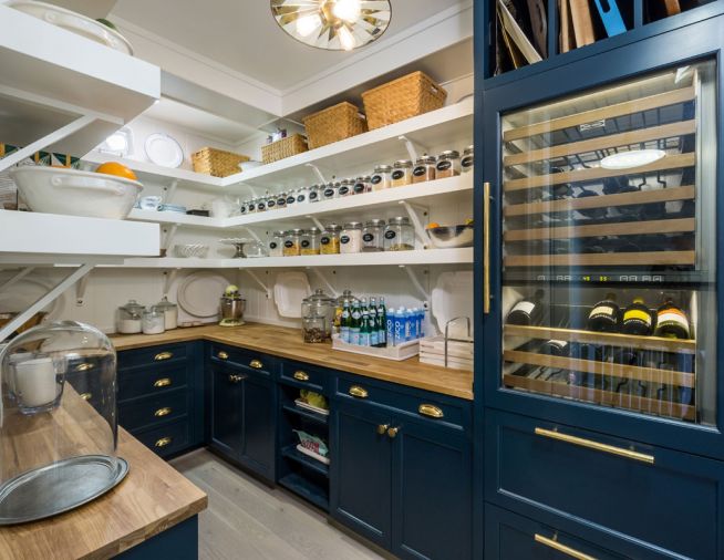 The pantry’s shelving and cabinets hold a wine refrigerator and storage space for the family’s bulk purchases. Counters are from Ikea.
