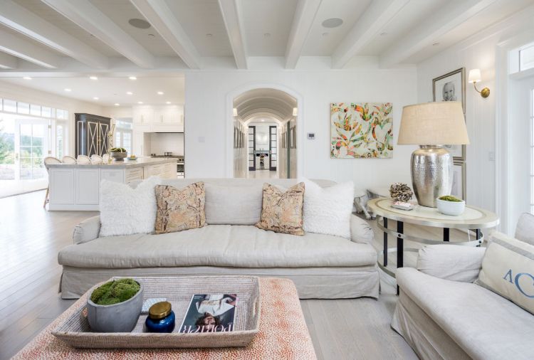 The elegantly paneled and arched hallway provides gallery space for family photographs. Blue pocket doors stand sentry at the living room. 