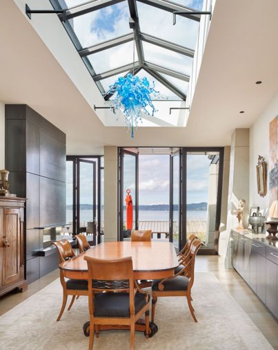 The dining room was designed to feel like a courtyard or breezeway, with natural light coming from multiple directions. “It’s really fun to have meals in there, especially in the summer when the doors are open,” says Peter.