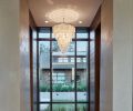 Many of the lighting fixtures were collected by the homeowners on their travels, including this statement chandelier off the kitchen.