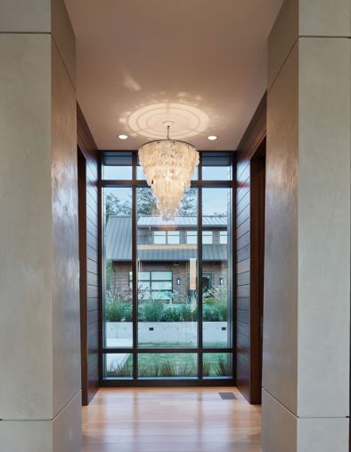 Many of the lighting fixtures were collected by the homeowners on their travels, including this statement chandelier off the kitchen.