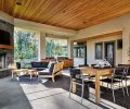 By placing the fireplace and grill on the perimeter of the covered outdoor patio, more space is given to lounging, dining, and the bar area with pass through, as well as great access to the laundry and pool bathroom. Cedar cabinets below the grill provide plenty of handy storage.