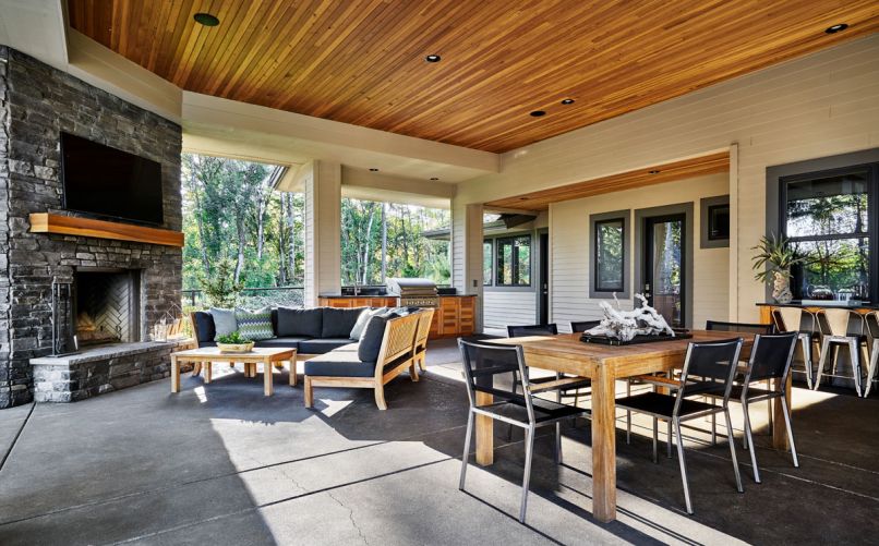 By placing the fireplace and grill on the perimeter of the covered outdoor patio, more space is given to lounging, dining, and the bar area with pass through, as well as great access to the laundry and pool bathroom. Cedar cabinets below the grill provide plenty of handy storage.