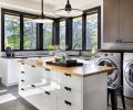 Multi-use counterspace can be used for folding laundry/crafts. Stools tuck beneath the lip when not in use. Industrial hood pendants by Rejuvenation, retro penny tile backsplash with dark grout adds punch.