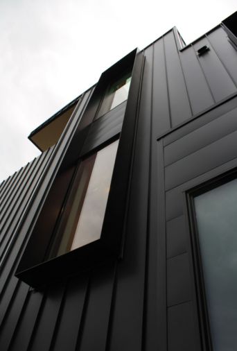 The metal-clad exterior features “fins” by Flux that shade windows and add to the seclusion.
