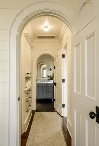 The horizontal board motif is carried through the staircase to the ground floor.