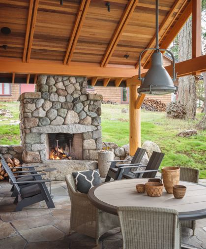 Outside the front door, the patio replicates the feel of a traditional living room, including a pendant light above the table. The fixture was reclaimed from a ship, where it was used to spot items in the water.