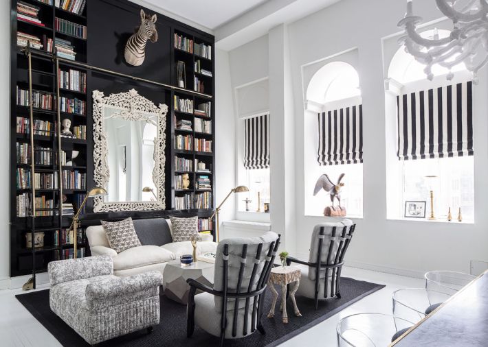 Howe’s custom bench done in marbleized silk by Claremont faces off with a pair of French chairs reupholstered in gray wool and juxtaposed against a spritely hoofed side table.